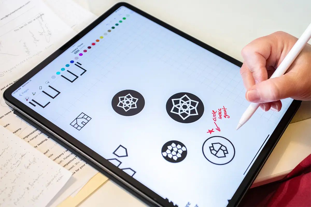 A designer making notes on a logo sketch