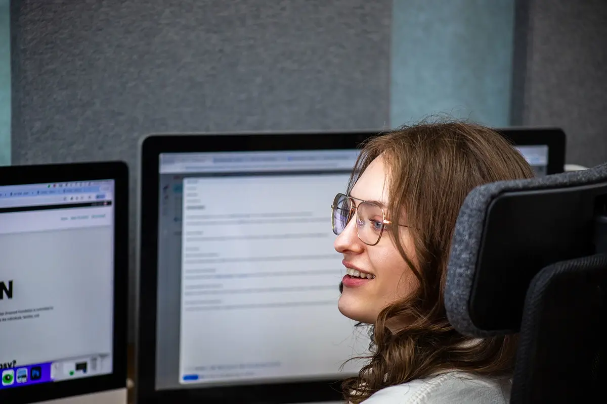 A woman sitting infront of computer