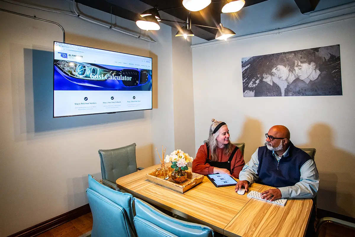 Vinod and Amy having a meeting in the conference room 