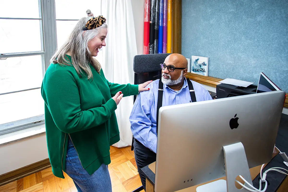 A female web designer collaborating with a male colleague .